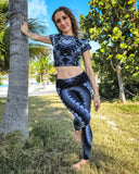 A blonge with curly hair wearing a matching tie dye outfit rockstar